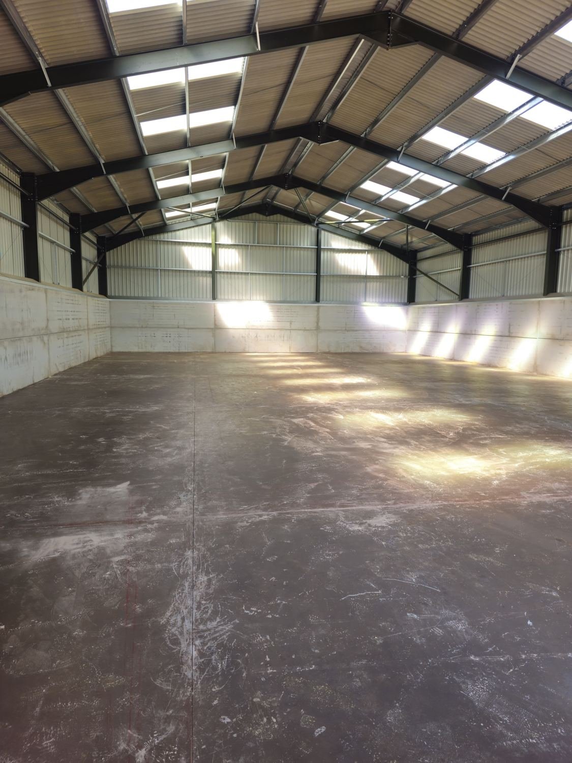 Large power-floated concrete floor inside a new steel-framed barn