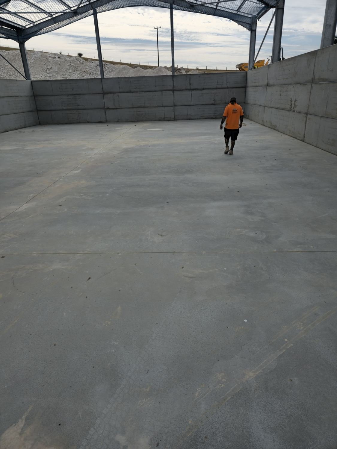 Finished concrete floor in a walled agricultural storage bay